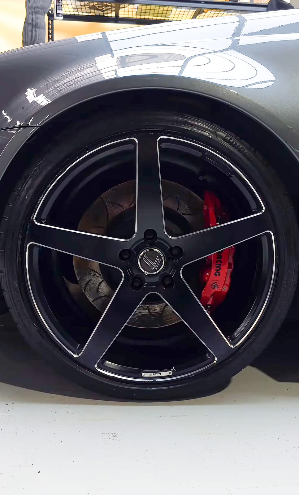 Wheel and red brake caliper, close-up